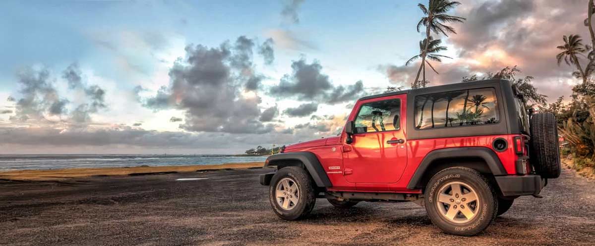 Rental Jeep sitting near a beach in Kauai Hawaii